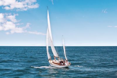 A sailboat on an open horizon at dusk