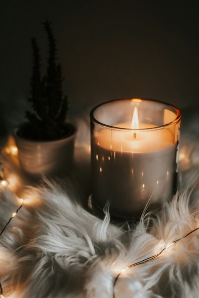 A single candle burning in low light